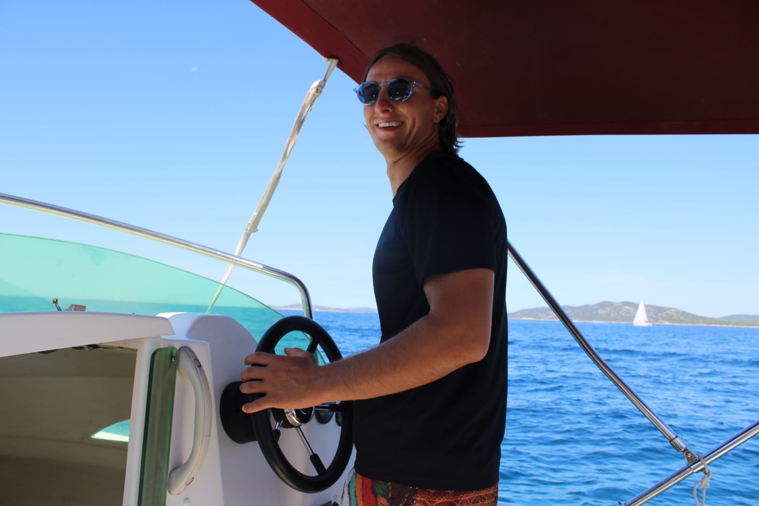 Luka teaching boat driving on the Adriatic near Vodice — private instruction session at the helm